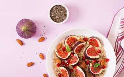 Delicious and healthy oatmeal with figs, almond and chia seeds. Healthy breakfast. Fitness food. Proper nutrition. Flat lay. Top view.
