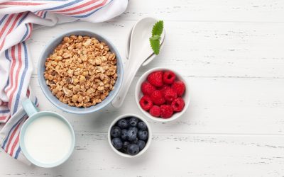 Healthy breakfast with homemade granola and fresh berries on wooden background. Top view with copy space